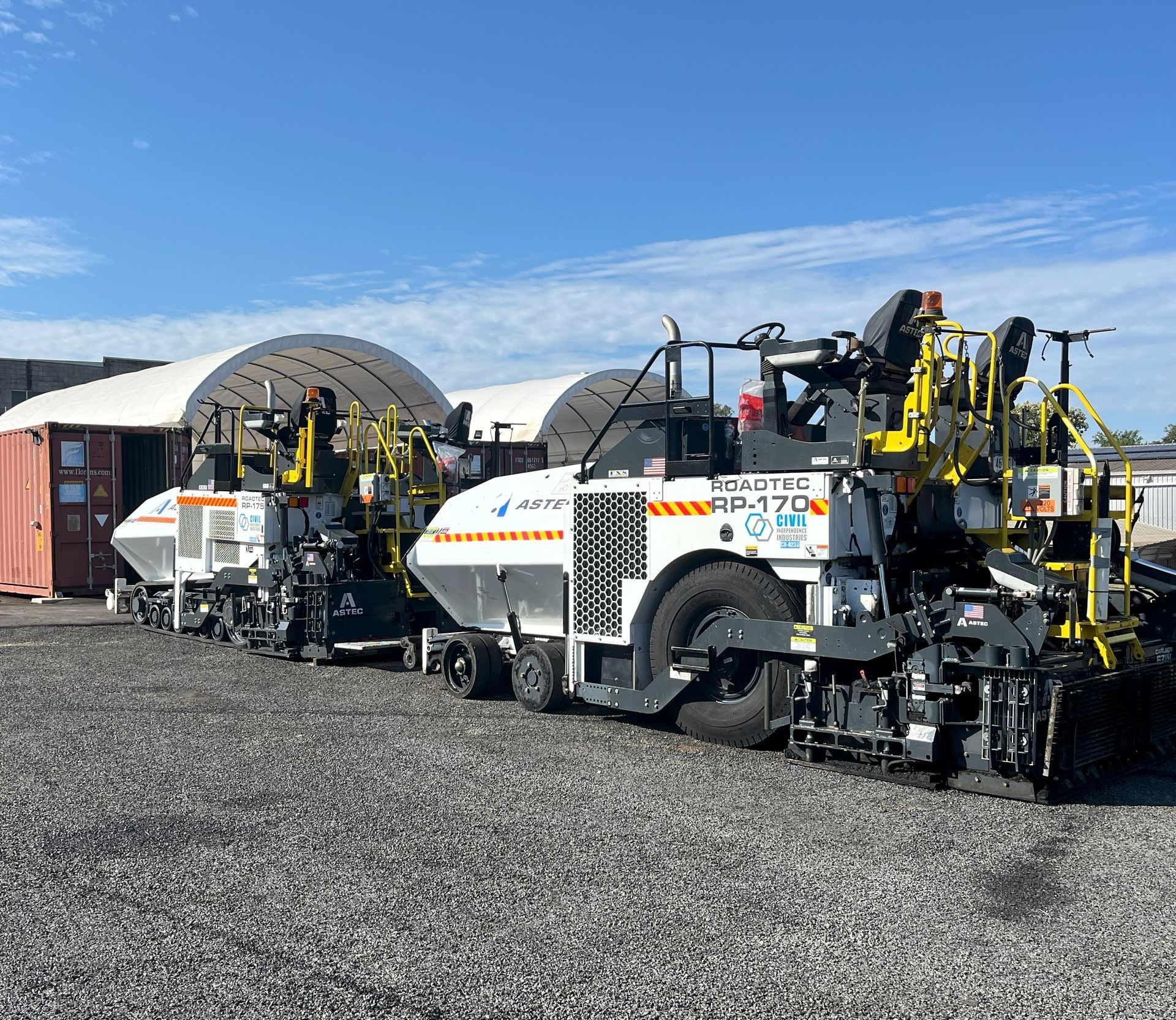 Freshly placed asphalt overlay being compacted by a CII roller on a regional road