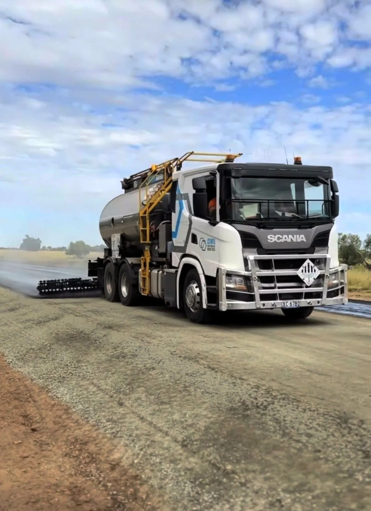 Civil Independence Industries bitumen sprayer applying binder on a regional road