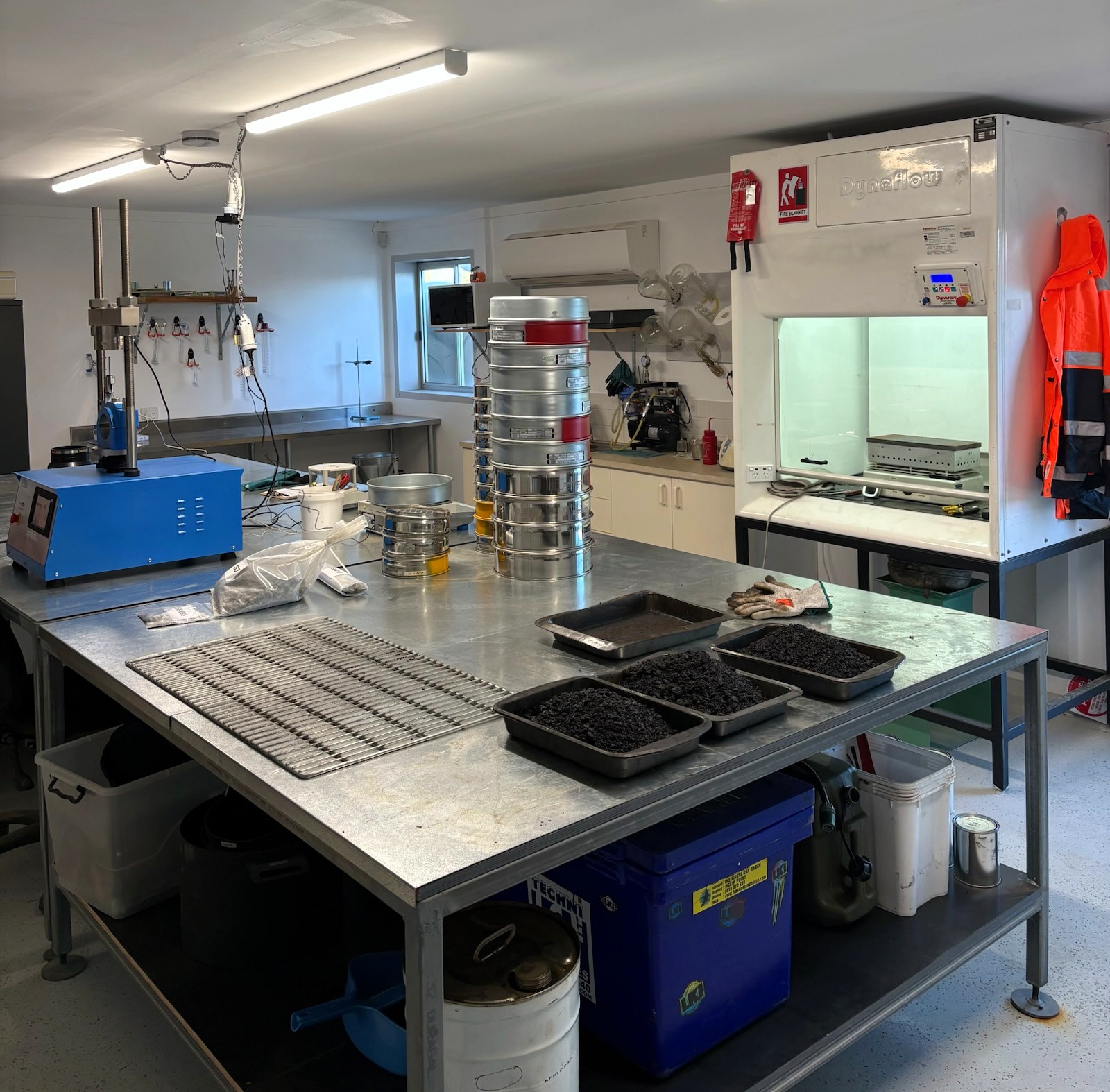 Civil Independence Industries asphalt laboratory with sieve stacks and prepared mix samples