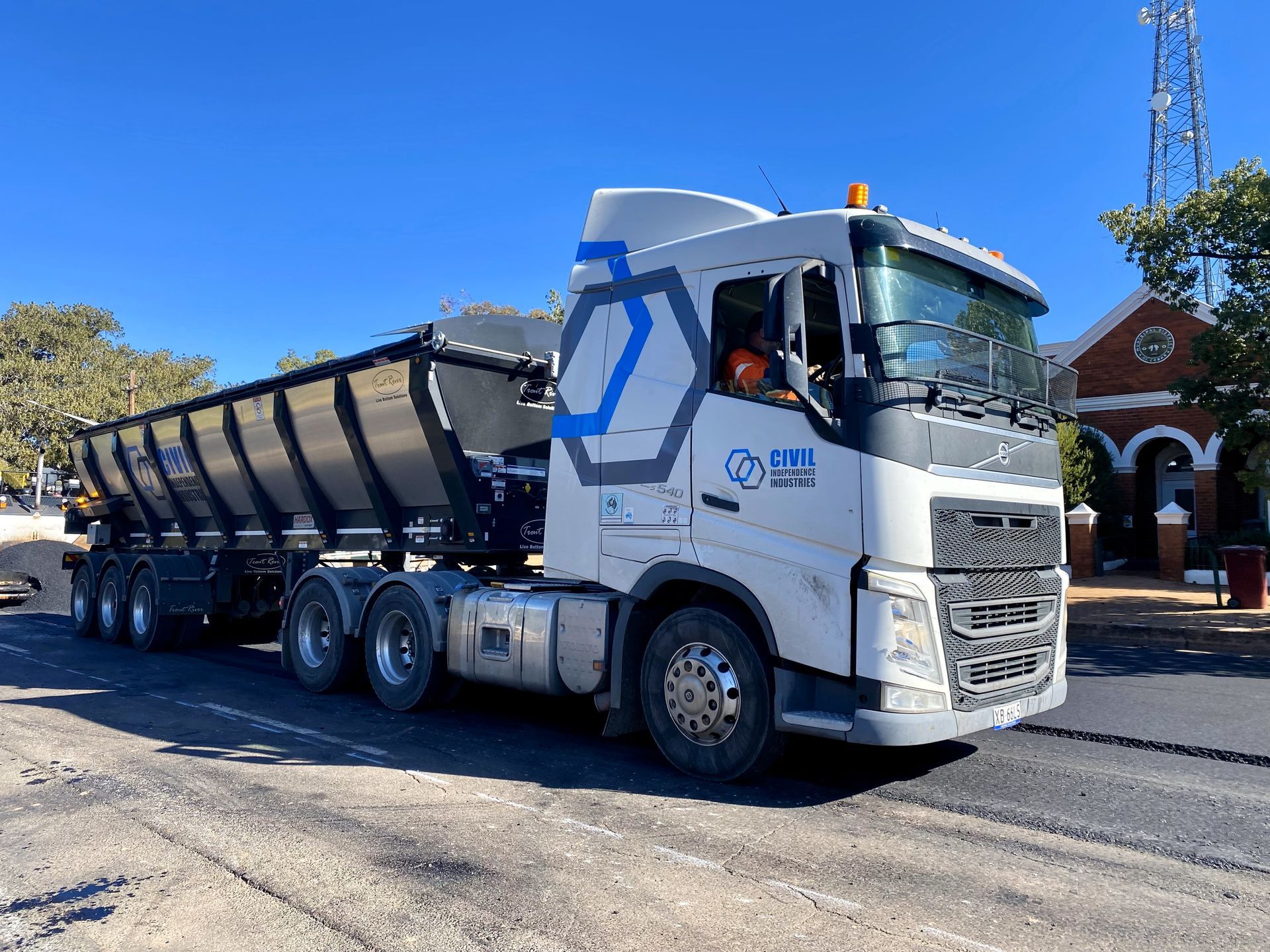 Multiple items of CII plant working across a full-width road construction operation