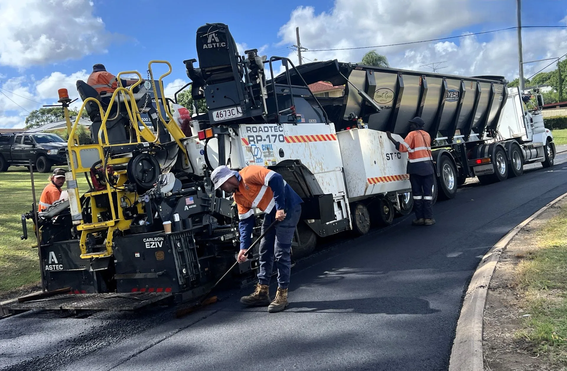 Civil Independence Industries paving crew placing asphalt behind a Roadtec paver on a residential street