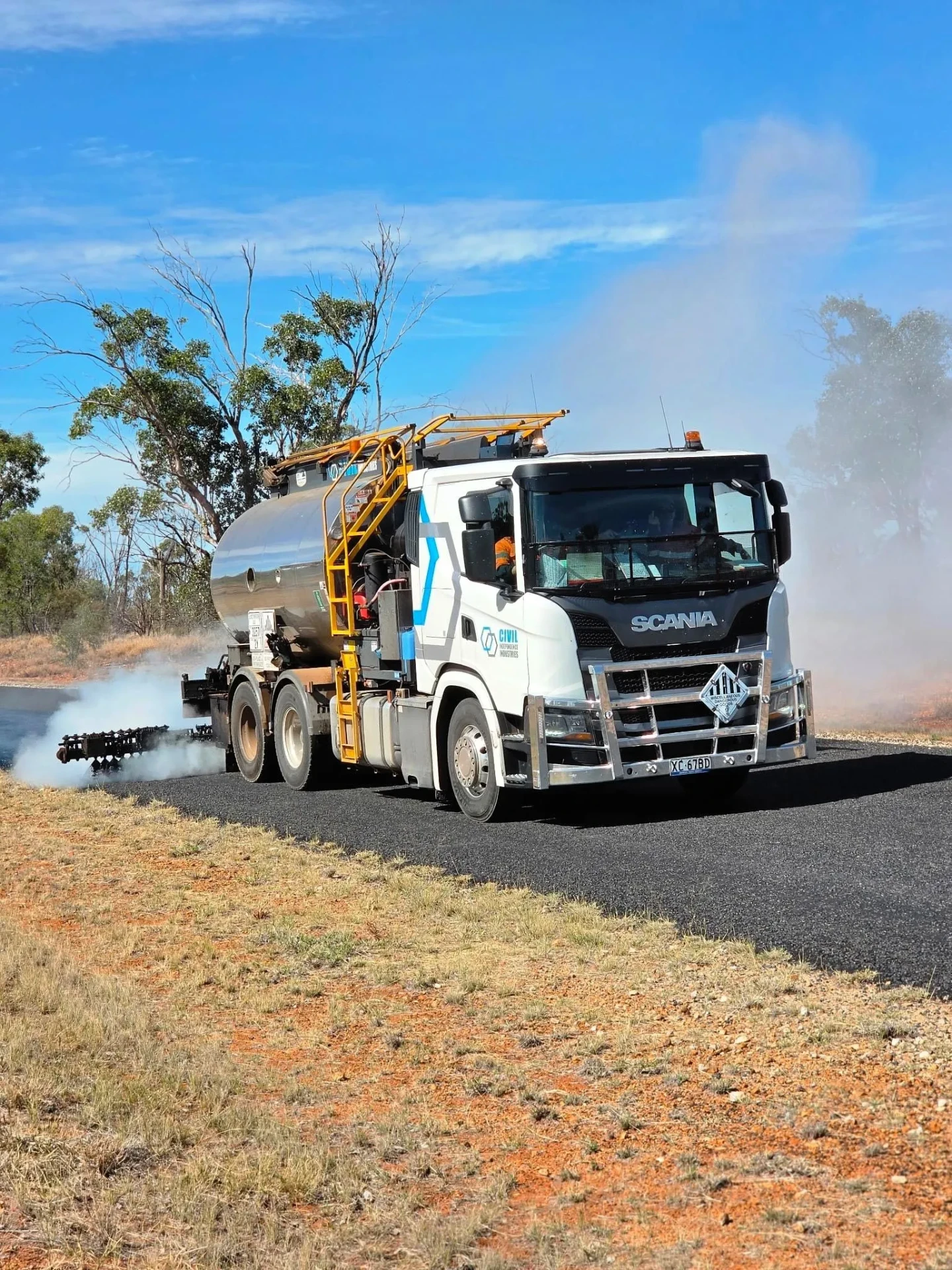 Civil Independence Industries Scania bitumen sprayer applying binder to a regional road